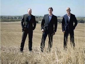 From left, CanopyLands’ project man­ager Will Schickedanz, project manager Gra­hamGreen, and pres­i­dent Asad Ni­azi stand on the site of the planned com­mu­nity of Cochrane North.