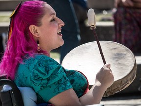 Organizer Chantal Chagnon sings at the welcome for a gathering at Olympic Plaza offering support for suicidal native youth across the country. Calgary, Ab., on Sunday April 17, 2016. Mike Drew/Postmedia