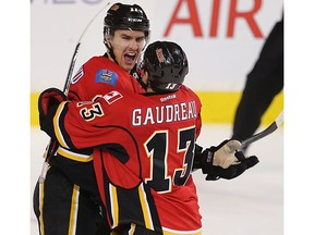 Calgary Flames Mikael Backlund the OT hero celebrates with Johnny Gaudreau after scoring against the Philadelphia Flyers during NHL hockey in Calgary, Alta. on Thursday November 5, 2015. Al Charest/Calgary Sun/Postmedia Network