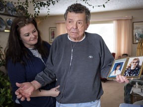 Nelson Smith, right, father of Canadian death row inmate Ronald Smith, holds a photo of Ronald taken in the early 1980's as Ronald's daughter Carmen looks on in Red Deer last March.