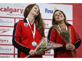 Meaghan Benfeito, right, and Caeli McKay, celebrate their silver medal in the women's 10-metre open synchro event at the Canada Cup FINA Diving Grand Prix in Calgary, Alta., Saturday, May 12, 2018.