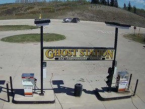 A screengrab from security footage shows the moment of impact between a stolen black Audi Q7 and a Ford Fusion outside of the Ghost Station service station.
