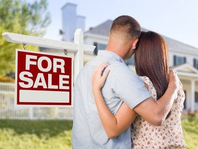 For Sale Real Estate Sign and Affectionate Military Couple Looking at Nice New House.