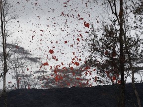 Lava shoot out of a fissure on Pohoiki Rd, Friday, May 18, 2018, near Pahoa, Hawaii.