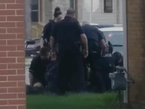 In this still image from video, Milwaukee police surround and try to subdue a suspect earlier this week.