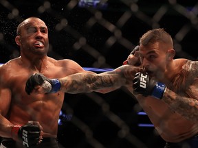 (L-R) Eddie Alvarez fights against Dustin Poirier in their Lightweight bout during UFC 211 at American Airlines Center on May 13, 2017 in Dallas, Texas.