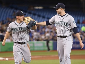 James Paxton of the Seattle Mariners congratulates Kyle Seager after a solid defensive play to preserve his no-hitter in the seventh inning against the Toronto Blue Jays at Rogers Centre on May 8, 2018 in Toronto. (Tom Szczerbowski/Getty Images)