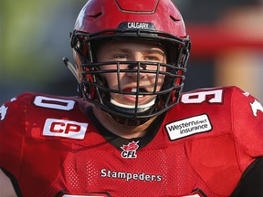 Quinn Smith of the Calgary Stampeders during player introductions before playing the Toronto Argonauts in CFL football in Calgary, Alta.. on Monday July 13, 2015. Al Charest/Calgary Sun/Postmedia Network