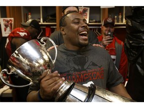 Nik Lewis of the Calgary Stampeders celebrates the team's win in the 102nd Grey Cup in their locker room at BC Place in Vancouver, B.C., on Sunday, Nov. 30, 2014. The Calgary Stampeders beat the Hamilton Tiger-Cats in the CFL championship game 20-16. Ian Kucerak/Edmonton Sun/ QMI Agency