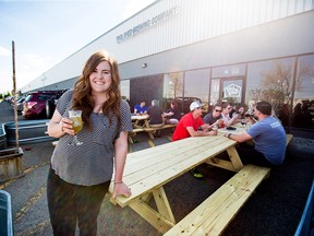 Andi Kowalski, officer manager with Tool Shed Brewing Company, raises a cool one on the company's newly approved patio on Monda, May 14, 2018. The company spent almost a year fighting City of Calgary red tape to get the small patio approved.