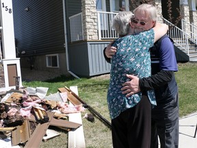 Marsha Bastarache hugs Calgary Transit bus driver Vincent Fleck on Tuesday morning May 15, 2018. Fleck was driving near the Bastarache home in Redstone at 1 AM when he noticed flames on the outside of the home. He quickly called 911 and woke the family of 6 and 2 pets and all escaped the fire. Gavin Young/Postmedia