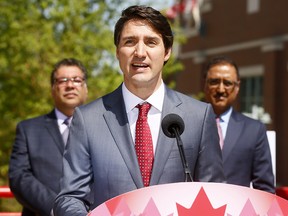 Prime Minister Justin Trudeau announces the federal government will follow through on its funding commitment to Calgary's Green Line on Tuesday May 15, 2018. Standing behind Trudeau is Mayor Naheed Nenshi, left, and 
Minister of Infrastructure Amarjeet Sohi.