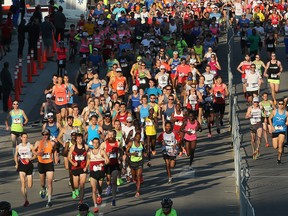 This file photo shows lead marathoners and half-marathoners race off down the starting stretch of the Scotiabank Calgary Marathon on Sunday, May 28, 2017.