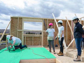Photo supplied 
The team from Excel Homes, including in white, Karen Baldwin, left, Jenn Fong, and Stephanie Chapman, at the Women Build event for Habitat for Humanity Southern Alberta in Bowness.