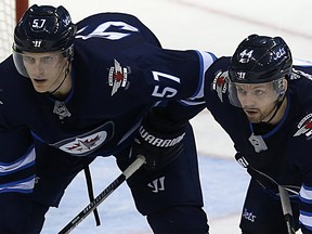 Winnipeg Jets defencemen Tyler Myers (left) and Josh Morrissey line up for a faceoff against the New York Rangers in Winnipeg on Sun., Feb. 11, 2018. Kevin King/Winnipeg Sun/Postmedia Network