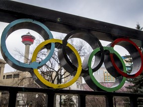 The Calgary Tower is seen with Olympic rings built into railing at Olympic Plaza in downtown Calgary, Alta., on Monday, March 20, 2017. The city is considering another Winter Olympics bid. Lyle Aspinall/Postmedia Network