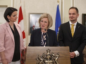 Alberta Premier Rachel Notley introduces Brian Malkinson as the new minister of Service Alberta and Danielle Larivee, left, who continues as minister of Child Services, with the added responsibility of minster responsible for the Status of Women, after a cabinet shuffle in Edmonton on Monday, June 18, 2018.