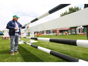 Spruce Meadows technical delegate Anthony D'Ambrosia measures a gate on the ATCO Challenge course in the Spruce Meadows International Ring on Tuesday June 5, 2018. The ATCO Challenge on Wednesday is the first event of the six day National show jumping competition. Gavin Young/Postmedia