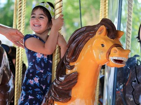 Natalie Myers has fun riding the horses on the carousel at Spruce Meadows on Wednesday June 6, 2018. The much loved Chinook Centre carousel has found a new home at Spruce Meadows.