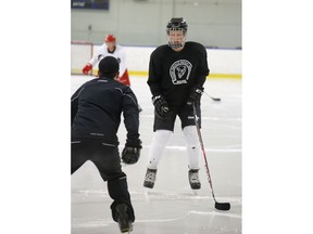 Aaron Konecsni of AKHockey works with Riley Sutter at a training session attended by Brett, Riley, Luke and Brody Sutter at Rose Kohn Arena in Calgary, Alta. on August 7, 2014. Mike Drew/Calgary Sun/QMI Agency