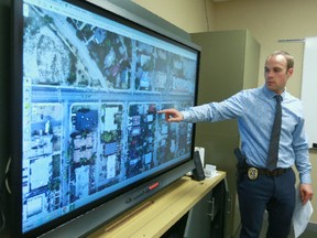 Const. Paul Teworte, a member of the Calgary Police Online Stolen Property Team reviews a city map and confirms a target address in the Beltline and containment by marked police units on Thursday, June 14, 2018 before joining the team and executing a search warrant later in the day. The specialized unit is the only team in Canada dedicated to researching and recovering many different types of property bought and sold online and they work closely with the Break and Enter Team. Jim Wells/Postmedia