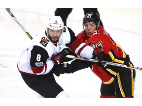 Coyotes Tobias Rieder (L) is blocked out by Flames Travis Hamonic during NHL action between the Arizona Coyotes and and the Calgary Flames in Calgary on Thursday, November 30, 2017. Jim Wells/Postmedia