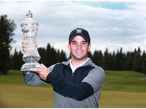 Étienne Papineau, from St-Jean-sur-Richelieu, QC raises the trophy after the winning the Glencoe Invitational golf tournament at the Glencoe Golf and Country Club in Calgary on Saturday, June 16, 2018. He won a threee round score of 1 over 217 en route to a four-shot victory. Jim Wells/Postmedia