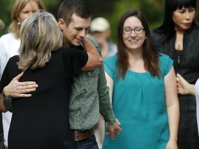 Eddie and Jessica Maurice hug supporters outsideProvincial Court in Okotoks, Ab., on Friday June 22, 2018, after the charges were dropped. Leah Hennel/Postmedia