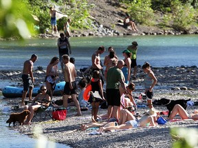 Swimmers and sunbathers gather on a gravel bar on the Elbow River just south of the 25th Avenue bridge in Mission in 2015.