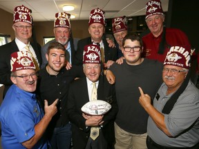 (L-R) Calgary Dino's, Zachary Newman and Daniel Stefanyk pose with Al Azhar Shriners Potentate, Ernie Hilland and other Shriners at Spolumbo's in Calgary as the two will travel to Montana to participate in an East-West Shrine Bowl football game with all proceeds of the game to benefit the Shriners Children's Hospital on Thursday June 14, 2018. Darren Makowichuk/Postmedia