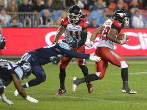 Toronto Argonauts defensive back Matt Webster (20) misses a tackle on Calgary Stampeders running back Terry Williams (38) during the second half of CFL football game action at BMO Field in Toronto, Ontario on Saturday June 23, 2018. THE CANADIAN PRESS/Cole Burston ORG XMIT: CLB108