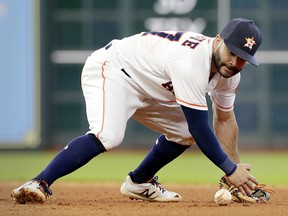 Houston Astros second baseman Jose Altuve (27) loses the ball on a hit by Toronto Blue Jays' Devon Travis (29) Wednesday, June 27, 2018, in Houston. (AP Photo/Michael Wyke)