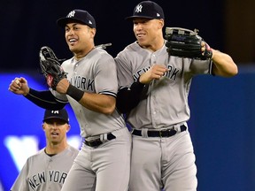 New York Yankees right fielder Aaron Judge, right, and Yankees left fielder Giancarlo Stanton celebrate after defeating the Toronto Blue Jays after thirteen innings American League baseball action in Toronto on June 6, 2018