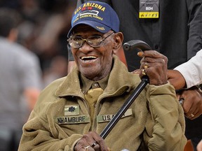 FILE - In this March 23, 2017, file photo, Richard Overton leaves the court after a special presentation honoring him as the oldest living American war veteran, during a timeout in an NBA basketball game between the Memphis Grizzlies and the San Antonio Spurs. (AP Photo/Darren Abate, File)