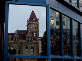 Old City Hall is reflected on the windows of new city hall in downtown Calgary.