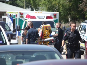 Paramedics take a man to hospital after he was shot in the 4600 block of Forman Cres. SE on July 20, 2018. (Zach Laing / Postmedia Network)