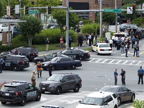 Maryland police officers block the intersection at the building entrance, after multiple people were shot at a newspaper in Annapolis, Md., Thursday, June 28, 2018. (AP Photo/Jose Luis Magana) ORG XMIT: MDJL105