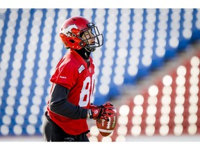 Eric Rogers jogs with a ball during a Calgary Stampeders practice at McMahon Stadium in Calgary, Alta. on Wednesday, Nov. 19, 2014.