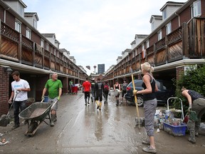 Residents and volunteers clear flood damage in  Erlton in the weeks after the 2013 flood.