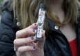 In this Wednesday, April 11, 2018 photo, an unidentified 15-year-old high school student displays a vaping device near the school's campus in Cambridge, Mass. (AP Photo/Steven Senne)
