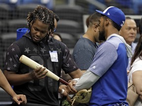 Vladimir Guerrero Jr.’s (left) weight gain is evidently a problem for the Jays, who plan to use him as a third baseman. (AP)