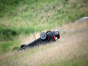 Emergency crews attend the scene of a single vehicle rollover on Aero Dr. NE on Saturday, June 16, 2018. Police were searching for two occupants who fled the scene.
