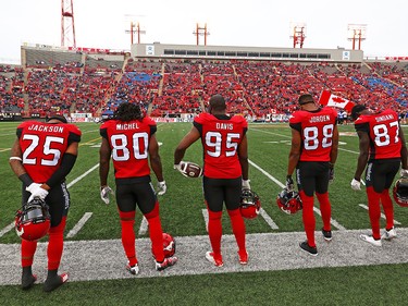 Players and fans take a moment of silence to honour former star player Larry Robinson who passed away this week. The Stampeders were playing against the Montreal Alouettes in CFL action at McMahon Stadium in Calgary on Saturday July 21, 2018.