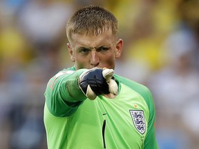 England goalkeeper Jordan Pickford points out to a teammate during Saturday's game against Sweden. (AP PHOTO)