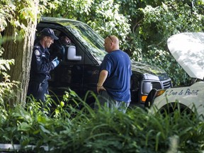 A van from the coroner's office prepares to leave a property on Mallory Cres. (ERNEST DOROSZUK, Toronto Sun)