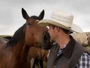 A bucking horse says hello to ranch manager Tyler Kraft at the Calgary Stampede Ranch south of Hanna, Ab., on Tuesday June 28, 2016. Mike Drew/Postmedia
