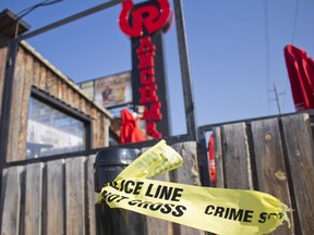 All that was left of the scene of a Friday night officer-involved shooting outside of Ranchman's was broken glass, tire tracks and police tape on July 28, 2018. (Zach Laing/Postmedia Network)