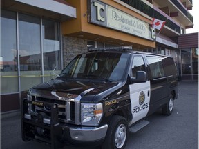 A Calgary police cruiser sits outside of the Town and Country Motel on July 28, 2018 a day after a man was shot and sent to hospital in serious condition.