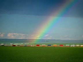 Rainbow over a a train crossing the prairie near Three Hills, Ab., on Sunday July 1, 2018. Mike Drew/Postmedia