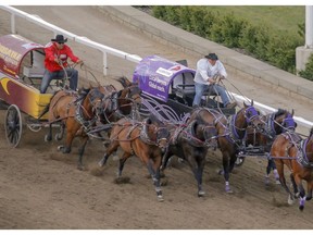 Vern Nolin, left, fights off Kurt Bensmiller to take Heat 9 of the chuckwagon races at the Calgary Stampede in Calgary, Ab., on Friday July 6, 2018. Mike Drew/Postmedia